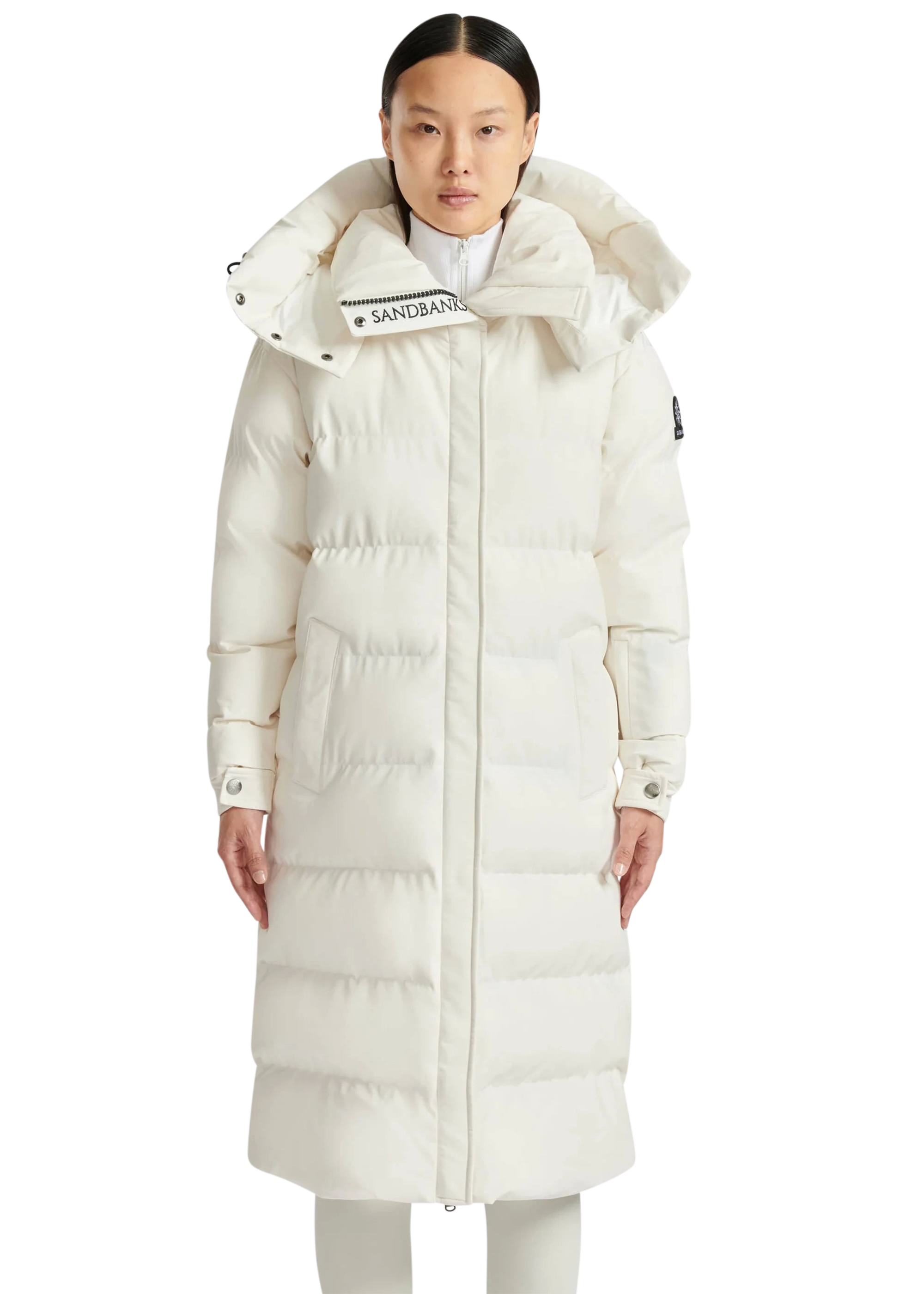 Person wearing a long white puffer coat with a brand logo on a white background
