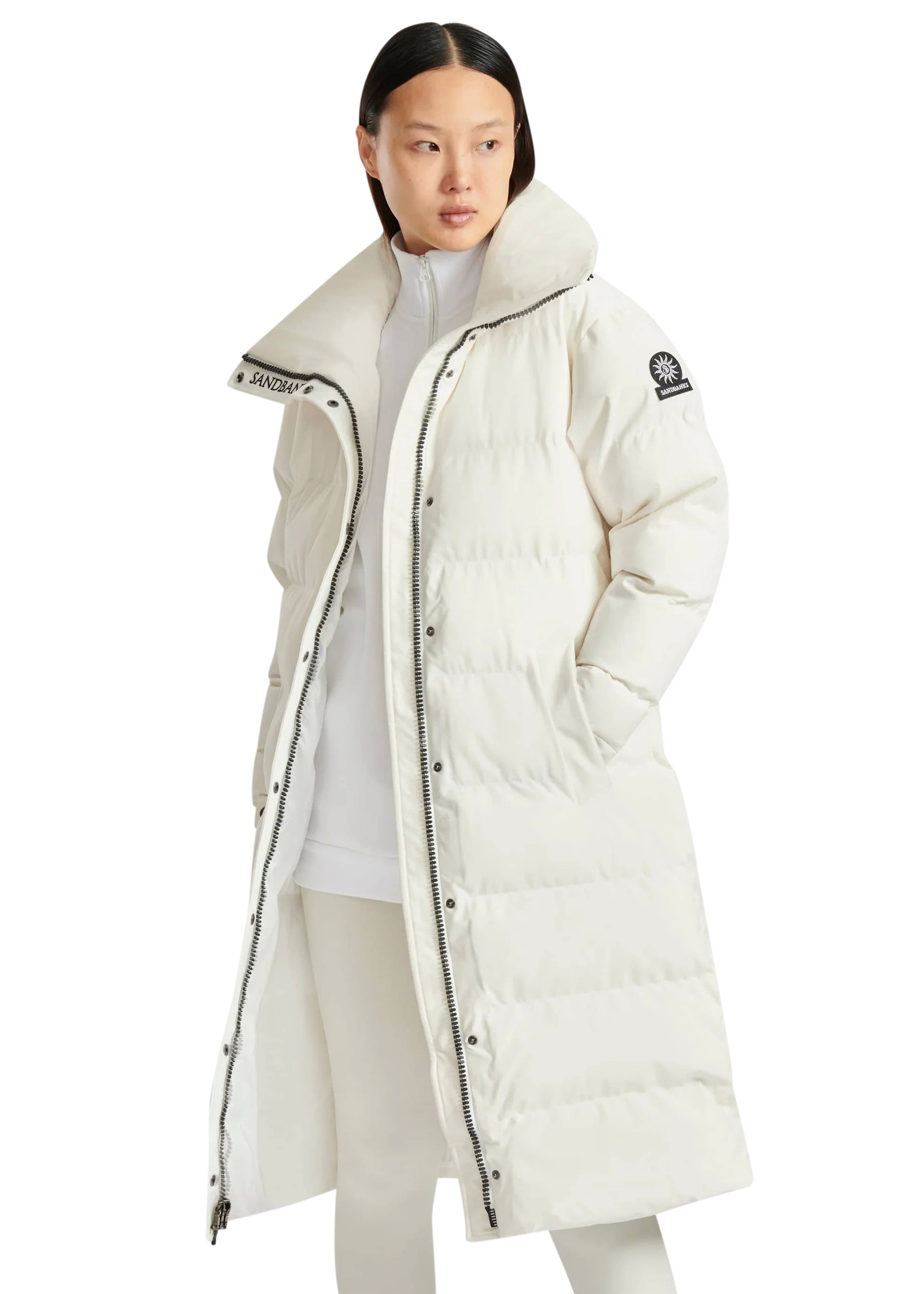 Person wearing a long white puffer coat with a brand logo on a white background