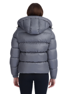 Gray puffer jacket worn by a person on a white background