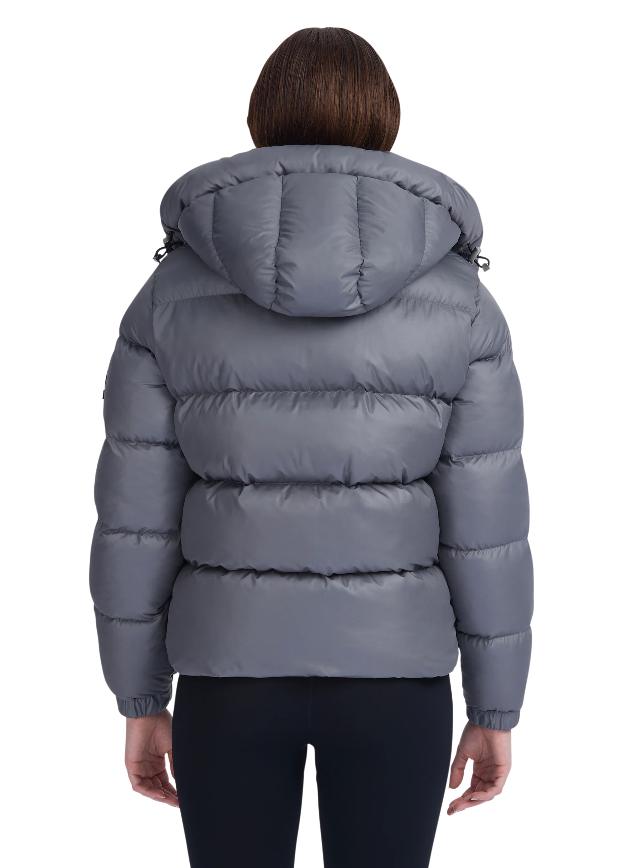 Gray puffer jacket worn by a person on a white background