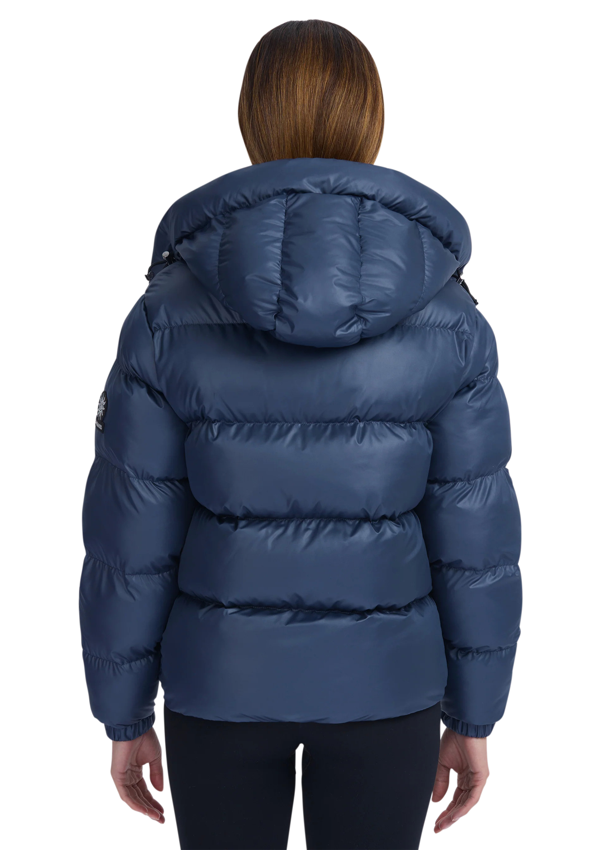 Blue puffer jacket worn by a person on a white background