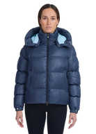 Woman wearing a blue puffer jacket with a hood on a white background