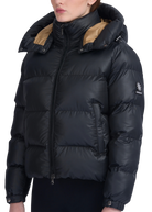 Black puffer jacket with beige lining on a white background