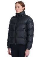 Woman wearing a black puffer jacket on a white background