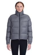 Woman wearing a gray puffer jacket on a white background