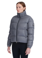 Woman wearing a gray puffer jacket on a white background