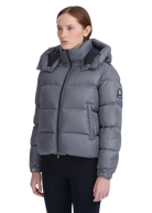 Woman wearing a gray puffer jacket on a white background