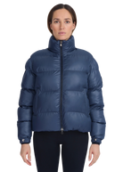 Woman wearing a blue puffer jacket on a white background
