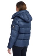 Person wearing a blue puffer jacket with a visible brand logo on a white background