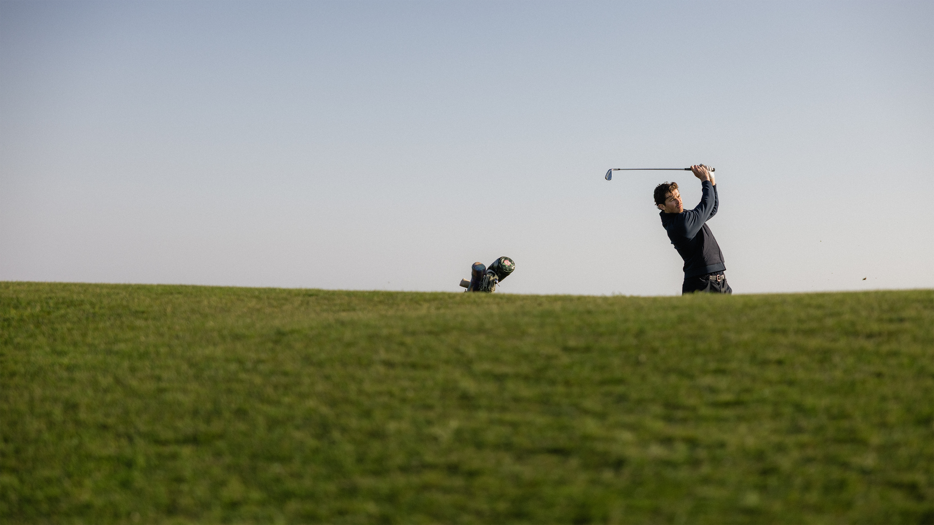 Sandbanks golf collection Person playing golf on a grassy field with a clear sky