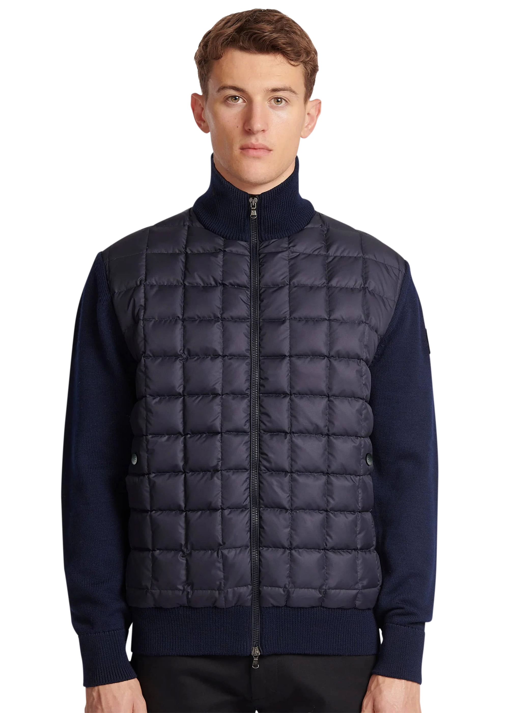Man wearing a navy puffer vest over a dark blue sweater on a white background