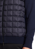 Navy quilted jacket with a close-up of the texture and zipper.