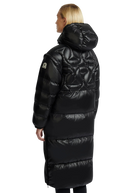 Person wearing a long black puffer coat on a white background