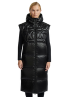 Woman wearing a long black quilted vest on a white background