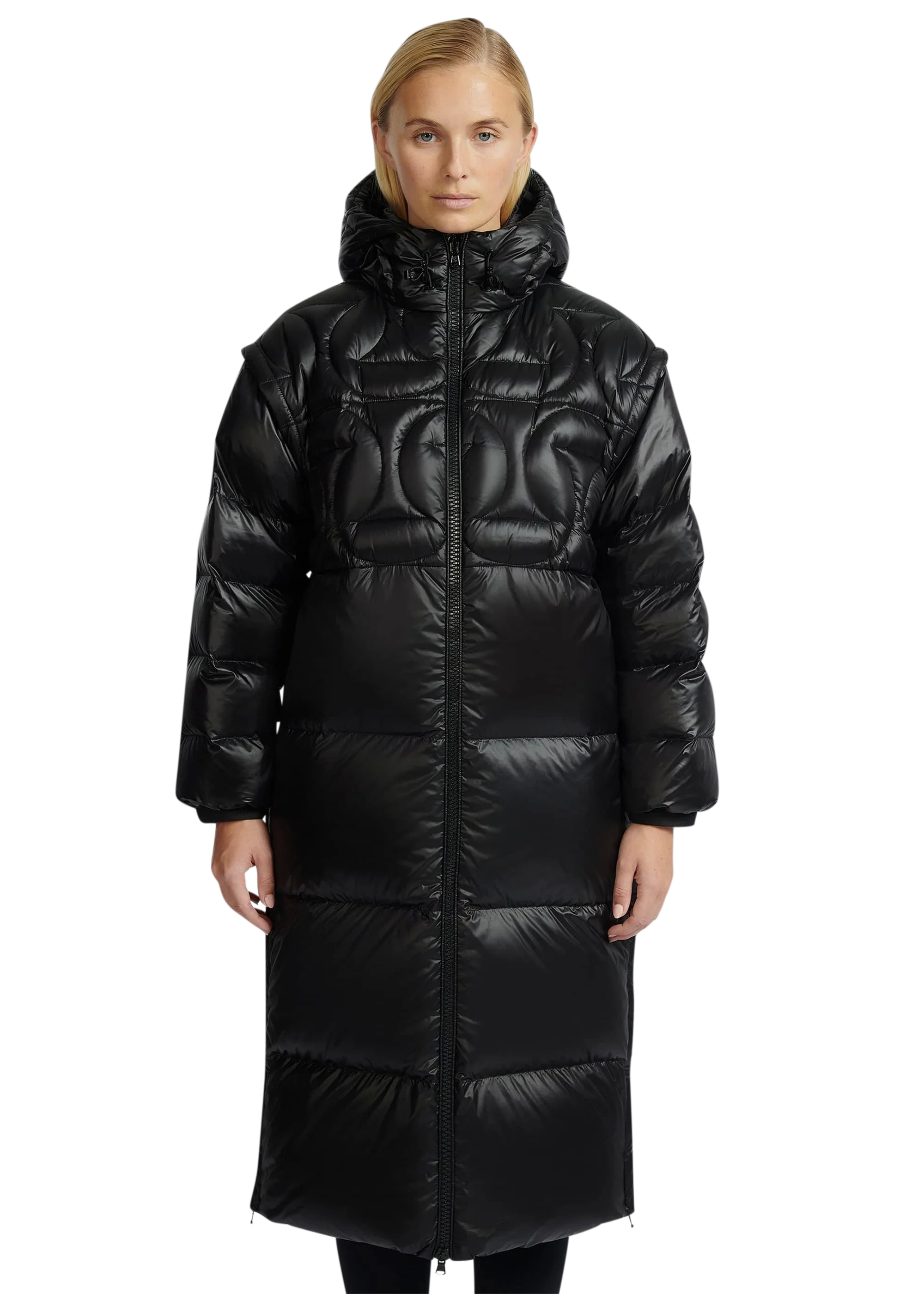 Woman wearing a black quilted coat on a white background