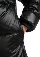 Close-up of a black puffer jacket on a white background