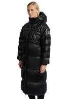 Woman wearing a black puffer coat on a white background