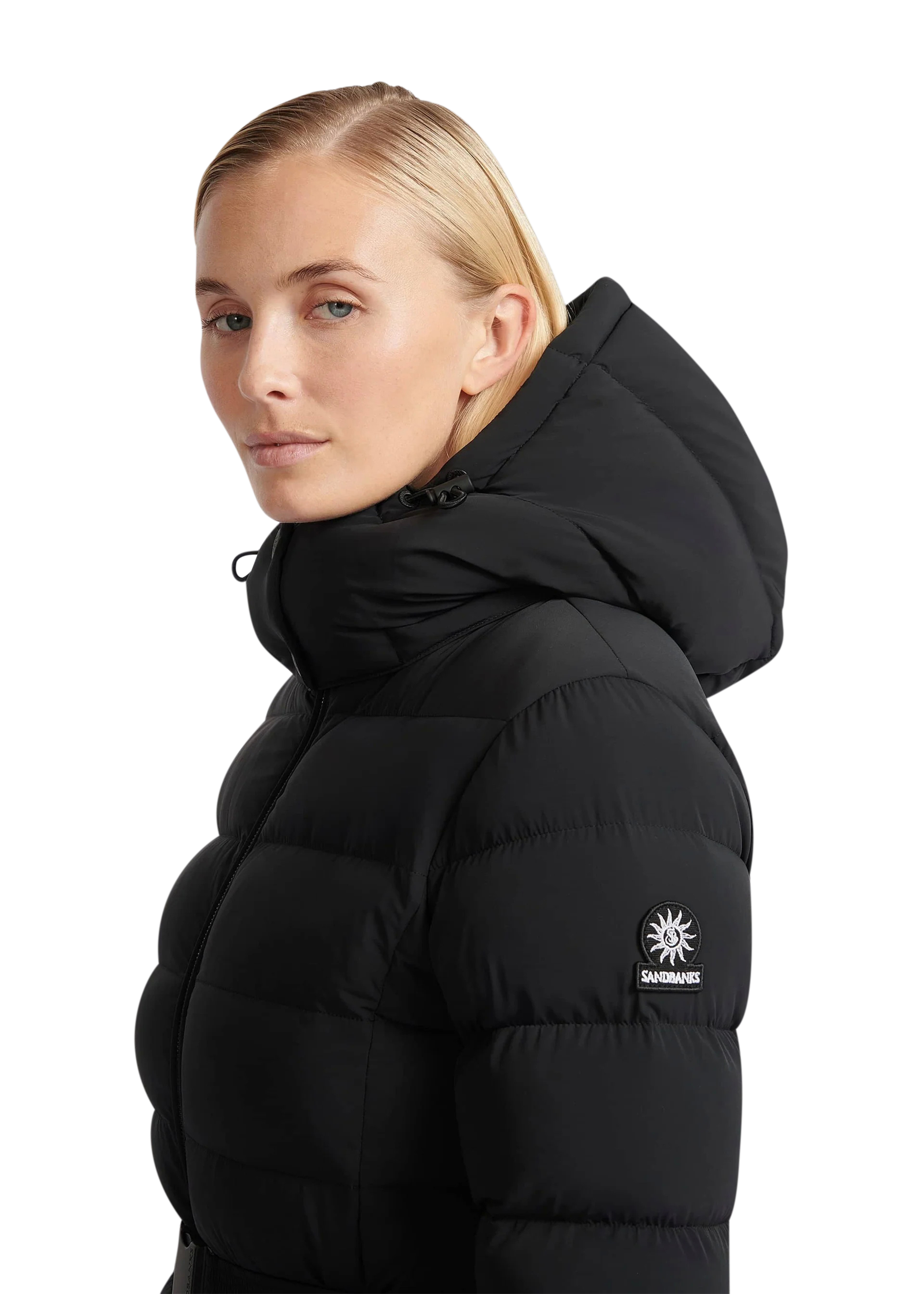 Woman wearing a black puffer jacket with a brand logo on a white background