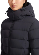 Black puffer jacket worn by a person on a white background