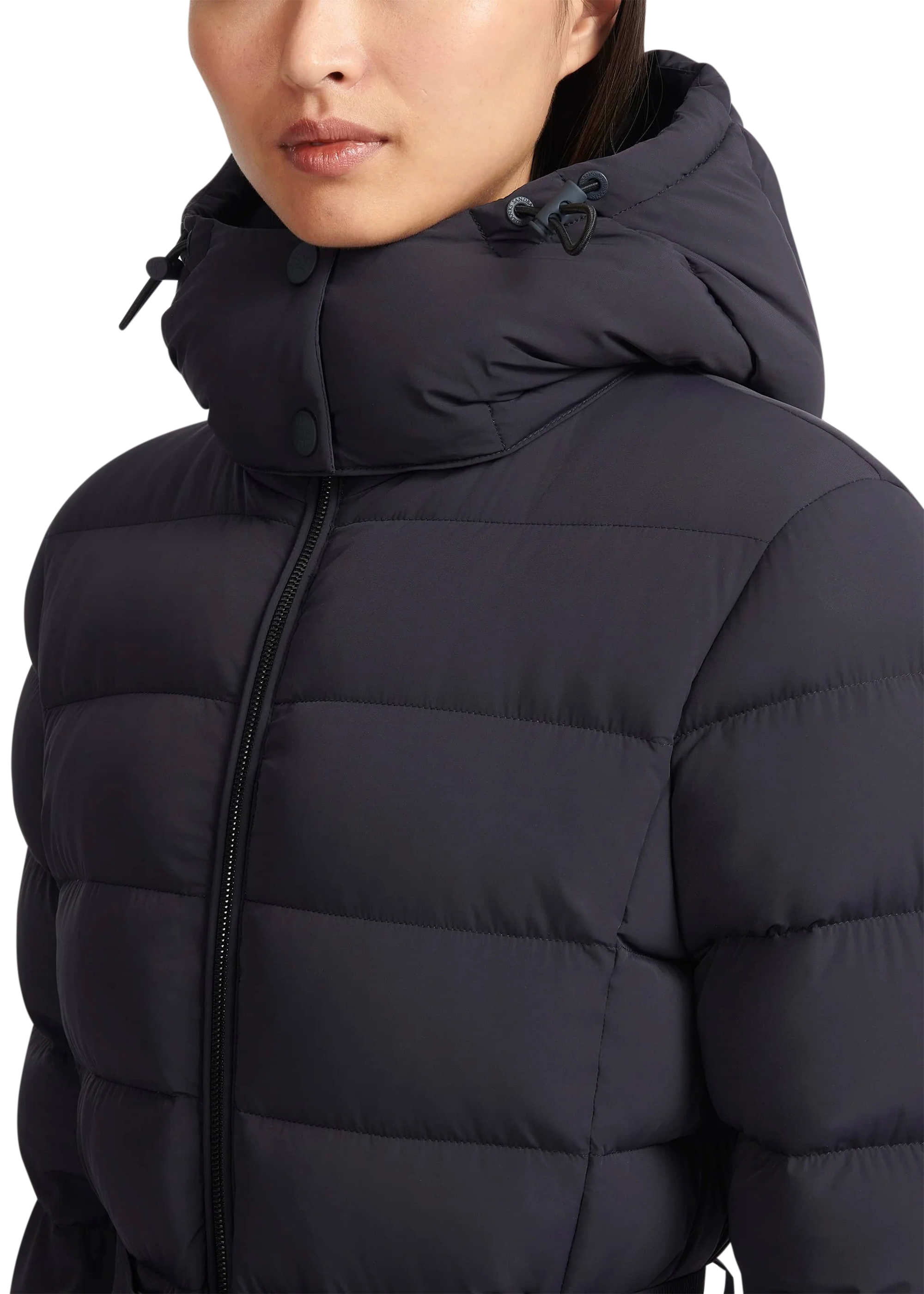 Black puffer jacket worn by a person on a white background
