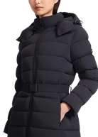 Black puffer coat worn by a person on a white background